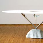 <p><strong><a href=andrea-branzi.html class=link-lightbox>Andrea Branzi</a></strong><br />Uomini e Fiori</p><p><strong>Flying</strong><strong> Table</strong><br />Elliptic table with  base in moulded concrete, structure in stainless<br />Steel with a small  round glass and adjustable cables. <br />Top in Lacquered wood.<br />195 x 104 x h. 74 cm.</p><p>Limited edition of 12  signed and numbered pieces.</p> 